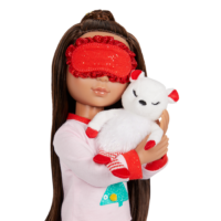 Doll wearing red blind fold while snuggling bear