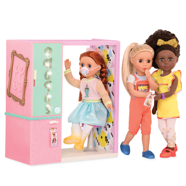 Three 14-inch dolls using toy photo booth