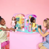 Kids playing with two 14-inch dolls in caravan home playset