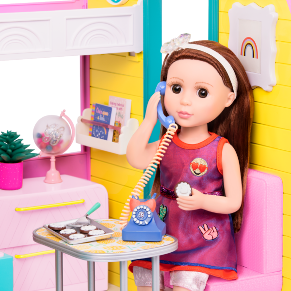 Doll sitting in home deco set with phone